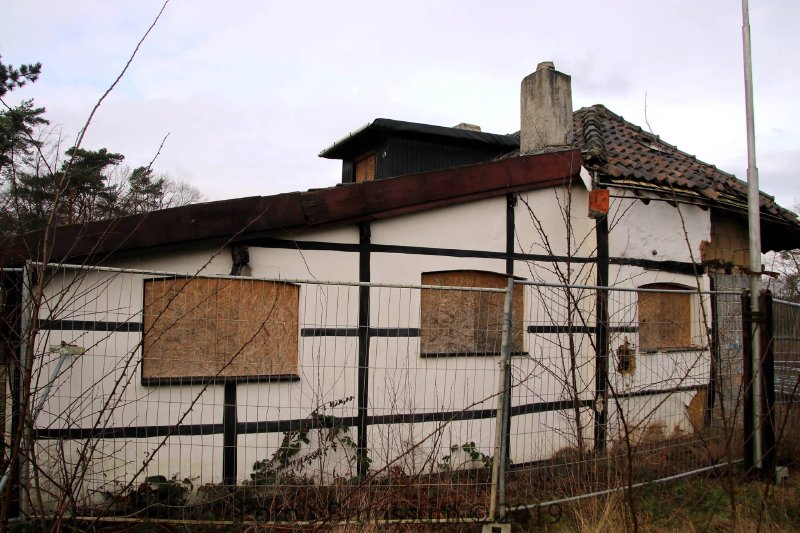The cottage with boarded windows and fencing, 2019